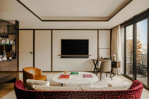 a living room with a couch and a table at Bvlgari Hotel Paris in Paris