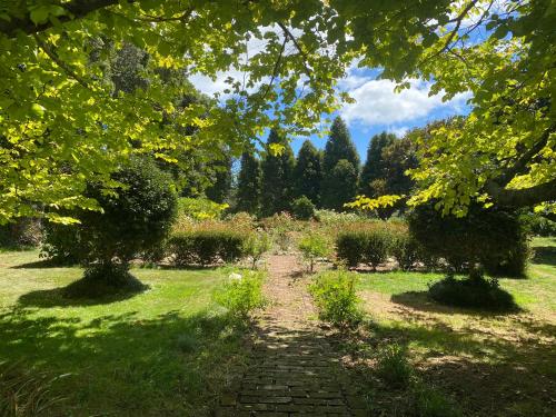 a path through a garden with trees and grass at Private Garden Oasis with Pool and Gym in Sentry Hill