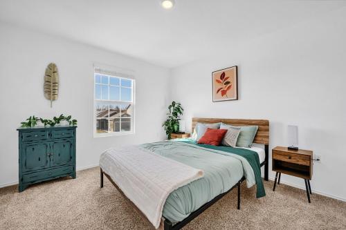a bedroom with a bed and a dresser and a window at Austin Hideaway - King Bed, Game Room, FREE Coffee in Pflugerville