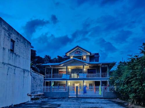 a house with its lights on at night at RedDoorz @ Garcia Hernandez Bohol in Garcia Hernandez