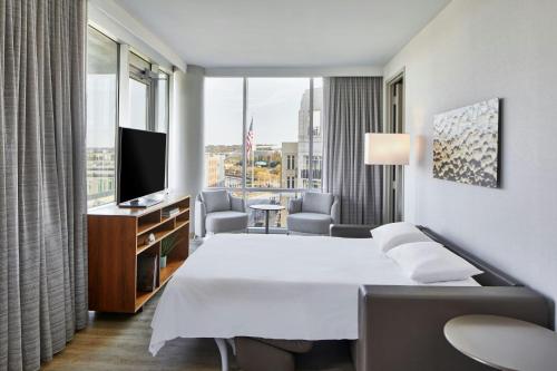 a hotel room with a bed and a large window at AC Hotel National Harbor Washington, DC Area in National Harbor