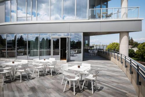 a balcony with tables and chairs on a building at Hotel Nia, Autograph Collection in Menlo Park