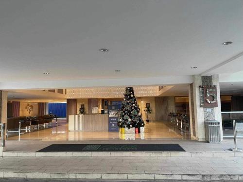 a christmas tree in the middle of a building at Field Residences Condo Hotel Near Manila Airport in Manila