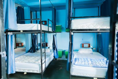 two bunk beds in a room with blue ceilings at Vientiane Ruby Riverside Hotel in Vientiane