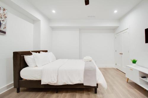 a white bedroom with a bed and a sink at Joonam Luxury Room For You In Peachtree Corners with Private Bath in Peachtree Corners