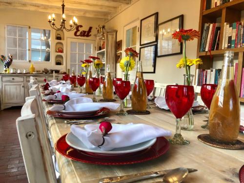 a long table with plates and wine glasses on it at Casa Culinaria - The Gourmet Inn in Santa Fe