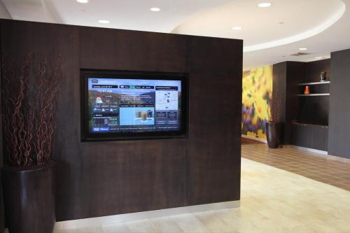 a flat screen tv on a wall in a room at Courtyard Rockaway-Mount Arlington in Mount Arlington