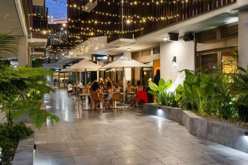 a group of people sitting at tables in a building at Jonson Lane Apartments in Byron Bay