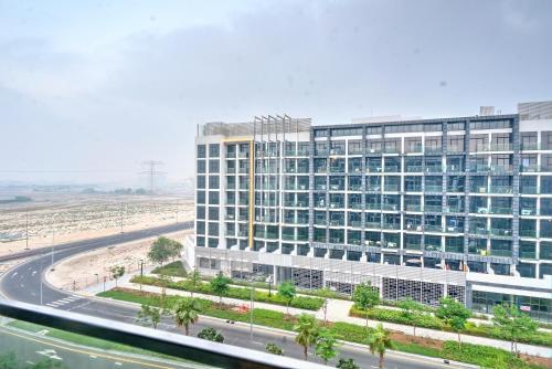 a large building with a road in front of it at Paradise Point in Dubai