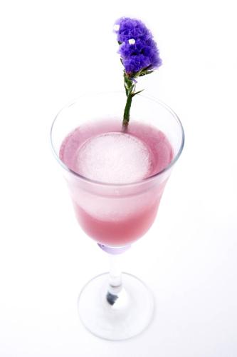 a glass with a purple drink with a flower in it at Aloft Kuala Lumpur Sentral in Kuala Lumpur