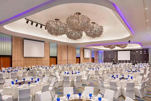 a large banquet hall with white tables and chairs at Aloft Kuala Lumpur Sentral in Kuala Lumpur