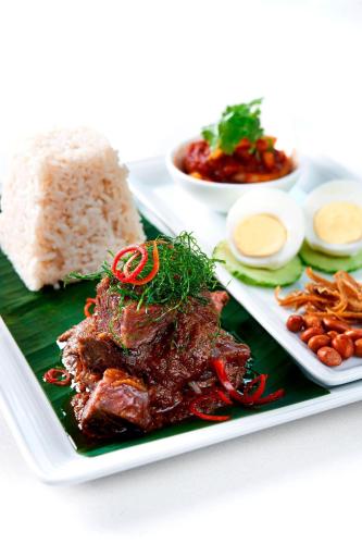 a plate of food with meat and rice and beans at Aloft Kuala Lumpur Sentral in Kuala Lumpur