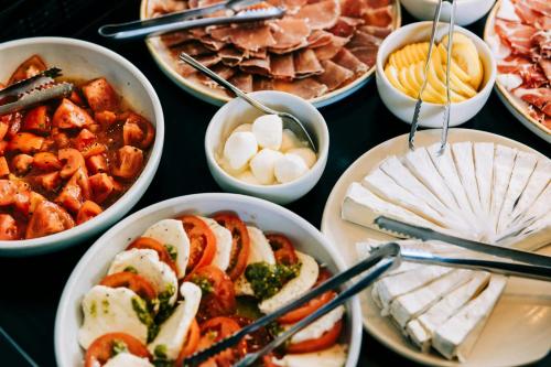 a table topped with bowls of different types of food at The Westin Perth in Perth