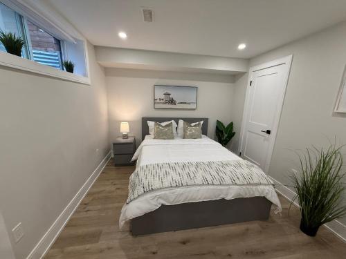 a bedroom with a bed and a window at Modern 1BR - Heart of Queen West in Toronto