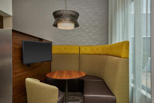 a living room with a couch and a table at Courtyard by Marriott Eugene Springfield in Springfield