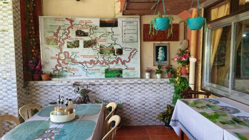 a dining room with a table and a table and chairs at People's lodge and restaurant in Banaue