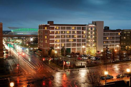 a city with buildings and street lights at night at Courtyard Omaha Downtown/Old Market Area in Omaha