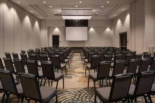 a conference room with chairs and a projection screen at Courtyard by Marriott Scottsdale Salt River in Scottsdale
