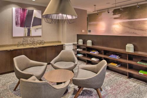 a waiting room with chairs and a table and a counter at Courtyard Clemson in Clemson