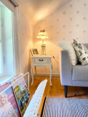 a living room with a laptop on a table and a couch at Wästinn in Vöyri