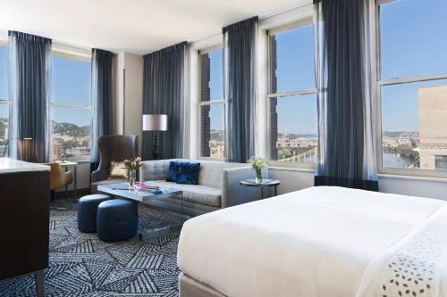 a hotel room with a bed and a couch at Renaissance Pittsburgh Hotel in Pittsburgh
