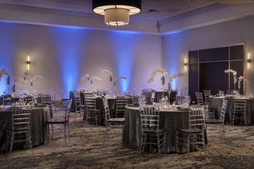 a ballroom with tables and chairs and a room filled with tables and chairsktop at Westchester Marriott in Tarrytown