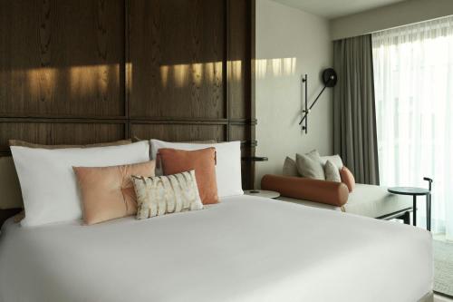 a bedroom with a large white bed with pillows at MonAsty, Thessaloniki, Autograph Collection in Thessaloniki