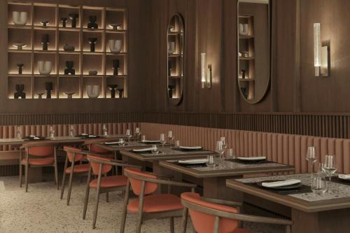 a dining room with tables and chairs and mirrors at MonAsty, Thessaloniki, Autograph Collection in Thessaloniki