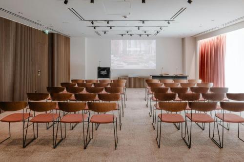 a room with rows of chairs and a podium at MonAsty, Thessaloniki, Autograph Collection in Thessaloniki