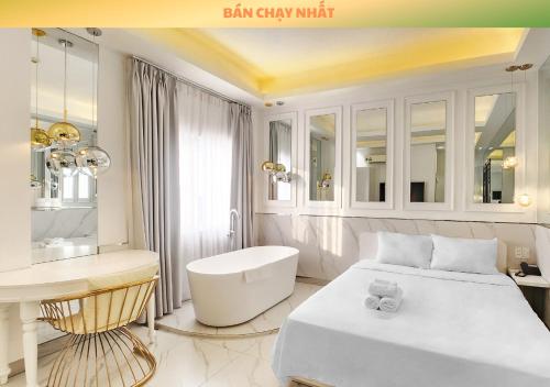 a bedroom with a bed and a sink and a desk at A In Hotel Atistar in Ho Chi Minh City