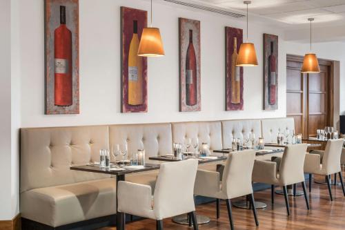 a dining room with a long table and chairs at Renaissance London Heathrow Hotel in Hillingdon