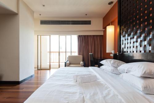 a large white bed in a hotel room at New Town Resort Suites at Pyramid Tower in Subang Jaya