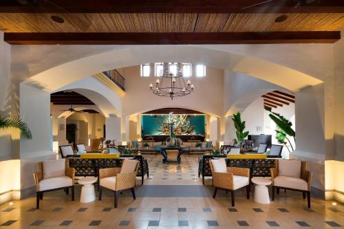 a lobby of a resort with chairs and a chandelier at The Buenaventura Golf & Beach Resort, Autograph Collection in Playa Blanca