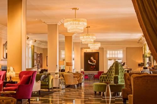 a lobby with chairs and chandeliers at The Historic Cavalier Hotel and Beach Club Autograph Collection in Virginia Beach
