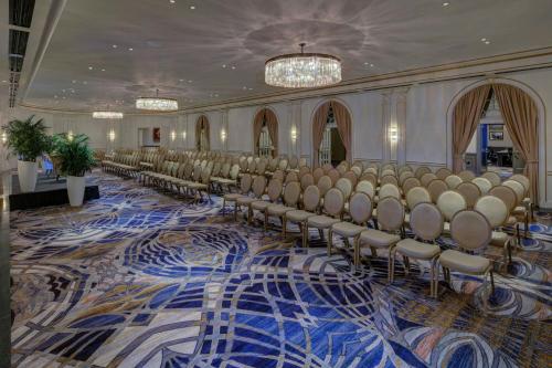 a large room with rows of chairs on a carpet at The Historic Cavalier Hotel and Beach Club Autograph Collection in Virginia Beach