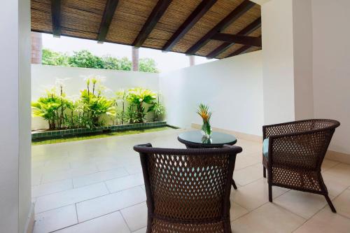 a dining room with a table and chairs and plants at The Buenaventura Golf & Beach Resort, Autograph Collection in Playa Blanca