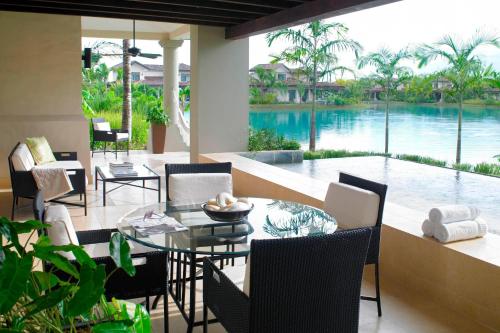 a dining room with a table and chairs and a pool at The Buenaventura Golf & Beach Resort, Autograph Collection in Playa Blanca