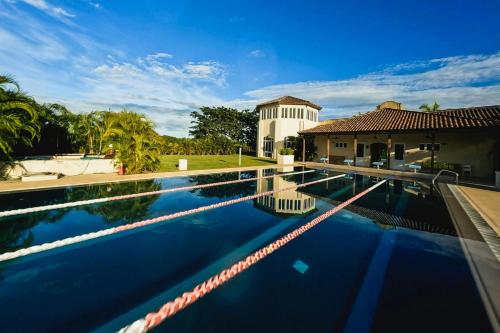 a swimming pool in front of a house at The Buenaventura Golf & Beach Resort, Autograph Collection in Playa Blanca