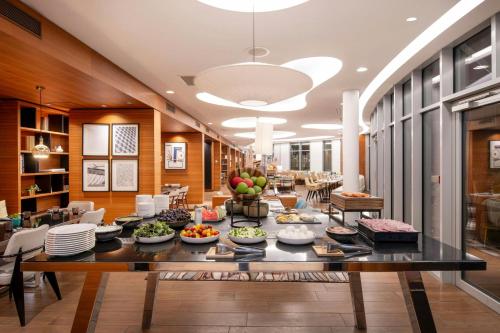a large dining room with a table filled with food at Renaissance Paris Republique Hotel & Spa in Paris