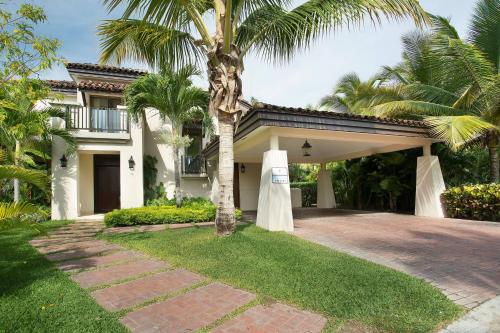 a house with a palm tree in front of a driveway at The Buenaventura Golf & Beach Resort, Autograph Collection in Playa Blanca
