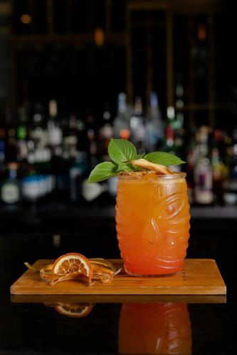 a drink on a wooden table with a slice of orange at The Buenaventura Golf & Beach Resort, Autograph Collection in Playa Blanca