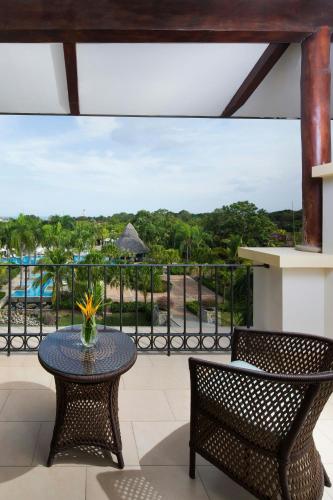 a patio with a table and chairs and a view of a pool at The Buenaventura Golf & Beach Resort, Autograph Collection in Playa Blanca