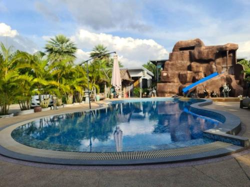 a pool at a resort with a water slide at SB Holiday Resort Chiang Mai - Villa Sofia in Chiang Mai