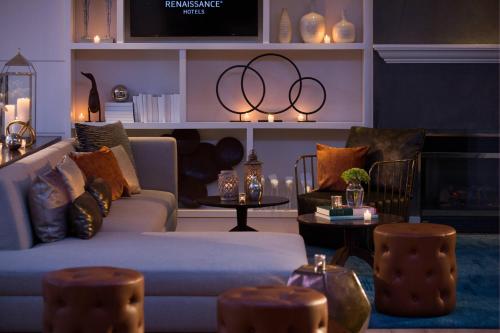 a living room with a couch and chairs and a table at Renaissance Meadowlands Hotel in Rutherford