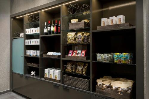a pantry with shelves filled with food and drinks at AC Hotel by Marriott Paris Le Bourget Airport in Le Bourget