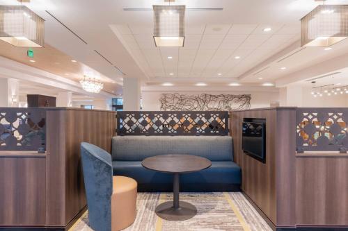 a cafe with a table and a blue chair at Courtyard by Marriott Thousand Oaks Agoura Hills in Agoura Hills