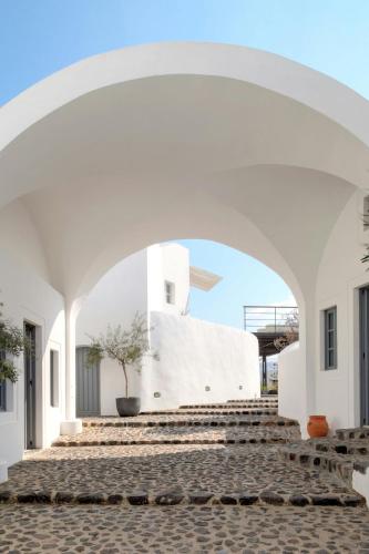 an archway leading up to a white building at Vedema, a Luxury Collection Resort, Santorini in Megalokhori