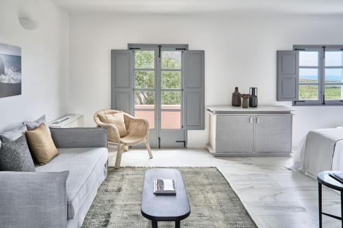 a white living room with a couch and a table at Vedema, a Luxury Collection Resort, Santorini in Megalokhori