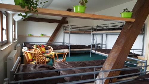 a room with two bunk beds and a couch at Penzion Eqilon in Mělník