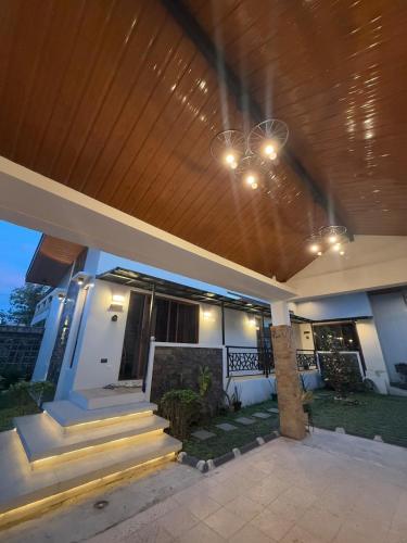 a house with a wooden ceiling and stairs in it at Cozy Home in Bacolod City near Airport & the Ruins in Bacolod